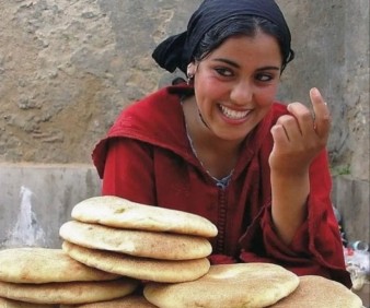 Moroccan girl selling bread in the street of Fez