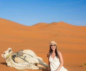 A woman tourist enjoying the dunes of Merzouga
